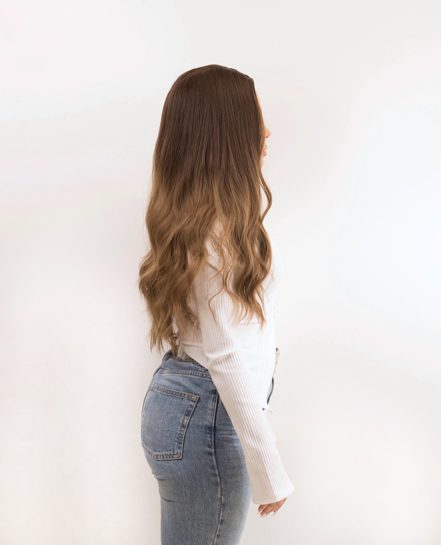 Back view of a highlighted brown wig, emphasising the soft waves and natural-looking balayage effect