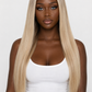 product A woman with long, straight, shoulder-length blonde hair with darker roots, wearing a white tank top and light blue jeans against a plain white background.