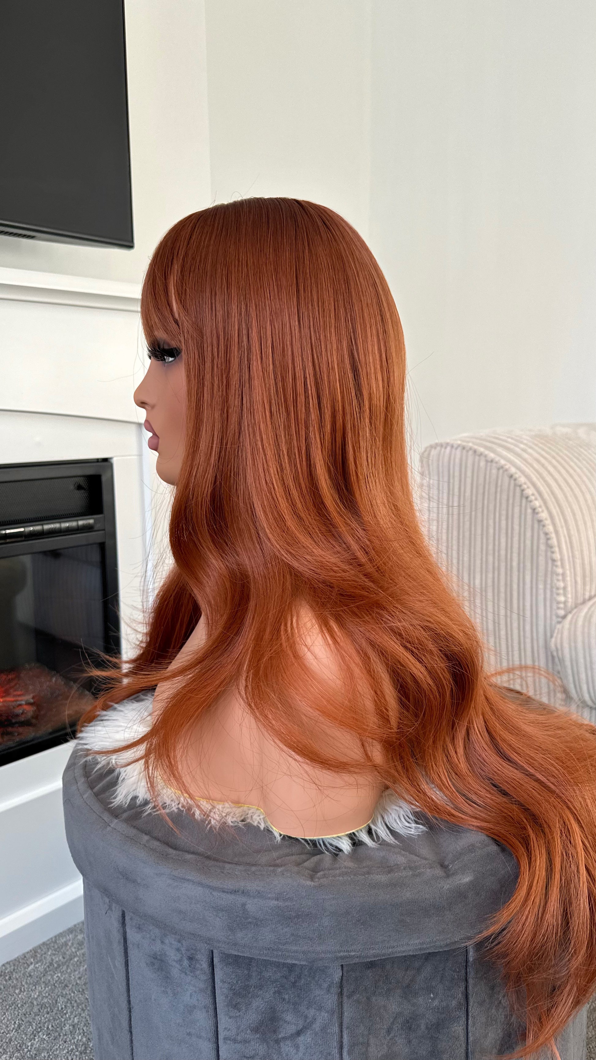 Closeup of vibrant ginger wig featuring a flawless fringe
