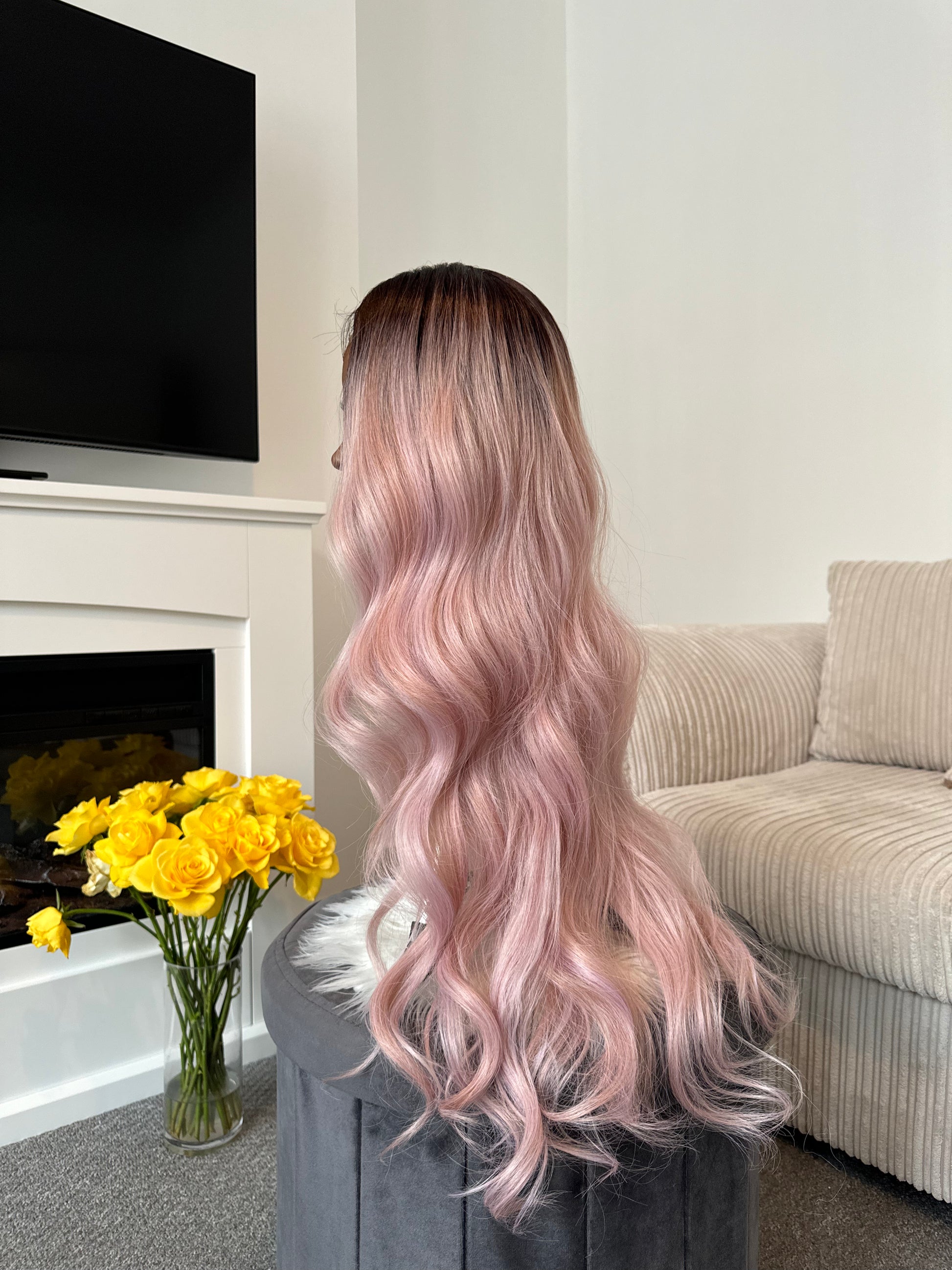 product: Full view of a long pink wavy lace front wig, highlighting the vibrant color and realistic texture