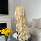 product Side view of a curly blonde wig with a lace front, showcasing the bouncy curls and natural-looking finish