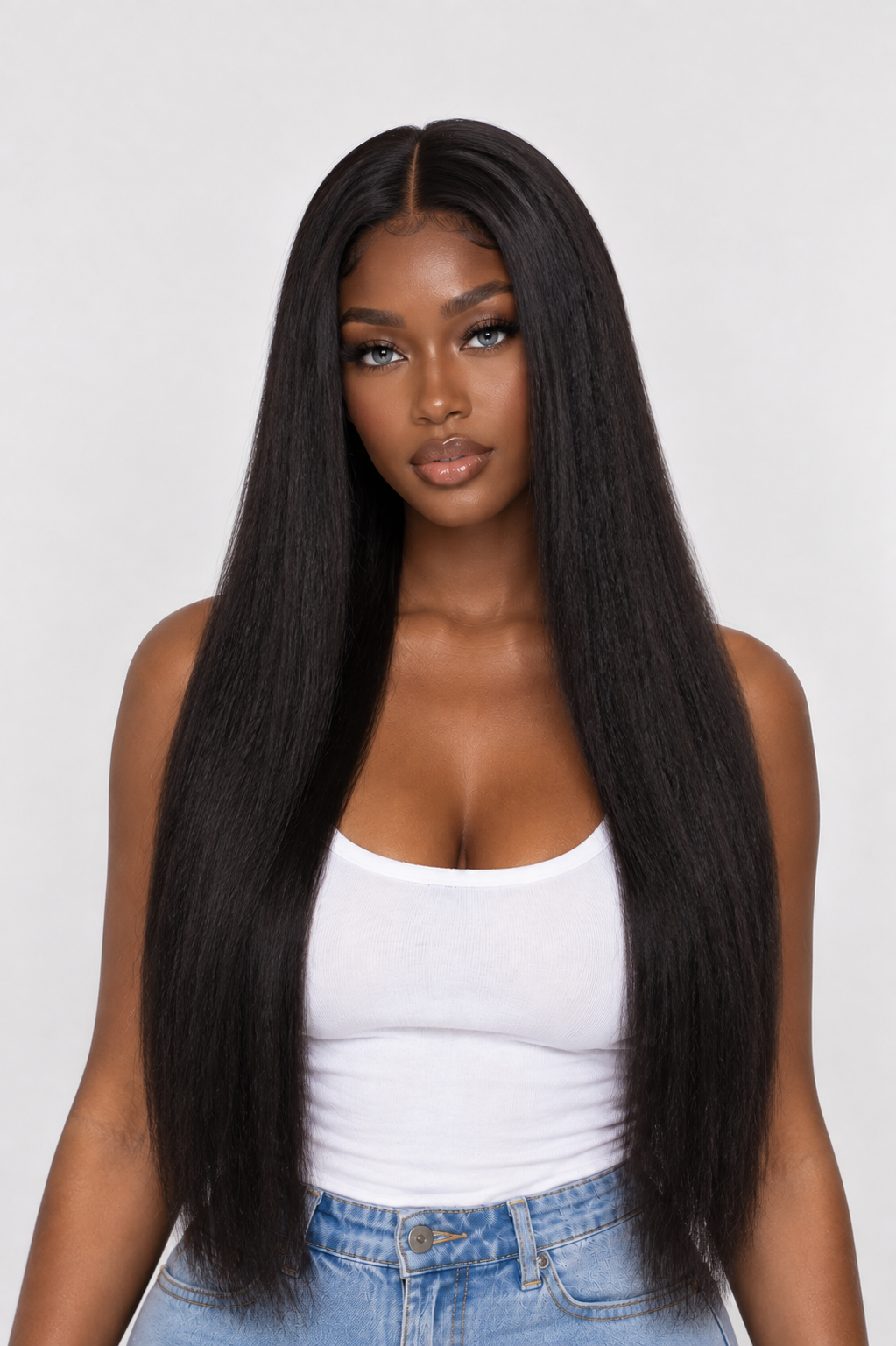 A woman modeling a long, straight, black wig with a center part against a light gray studio background. product