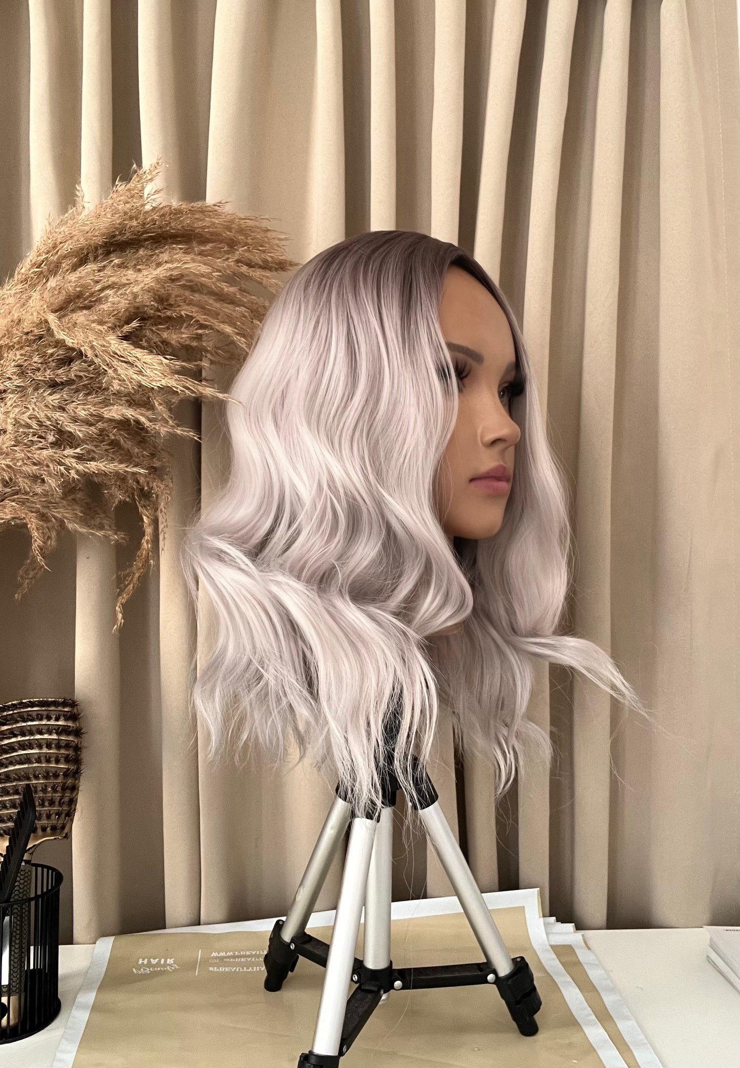 Close-up of a short grey bob wig made from synthetic hair, highlighting the modern style and texture