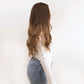 Back view of a highlighted brown wig, emphasising the soft waves and natural-looking balayage effect