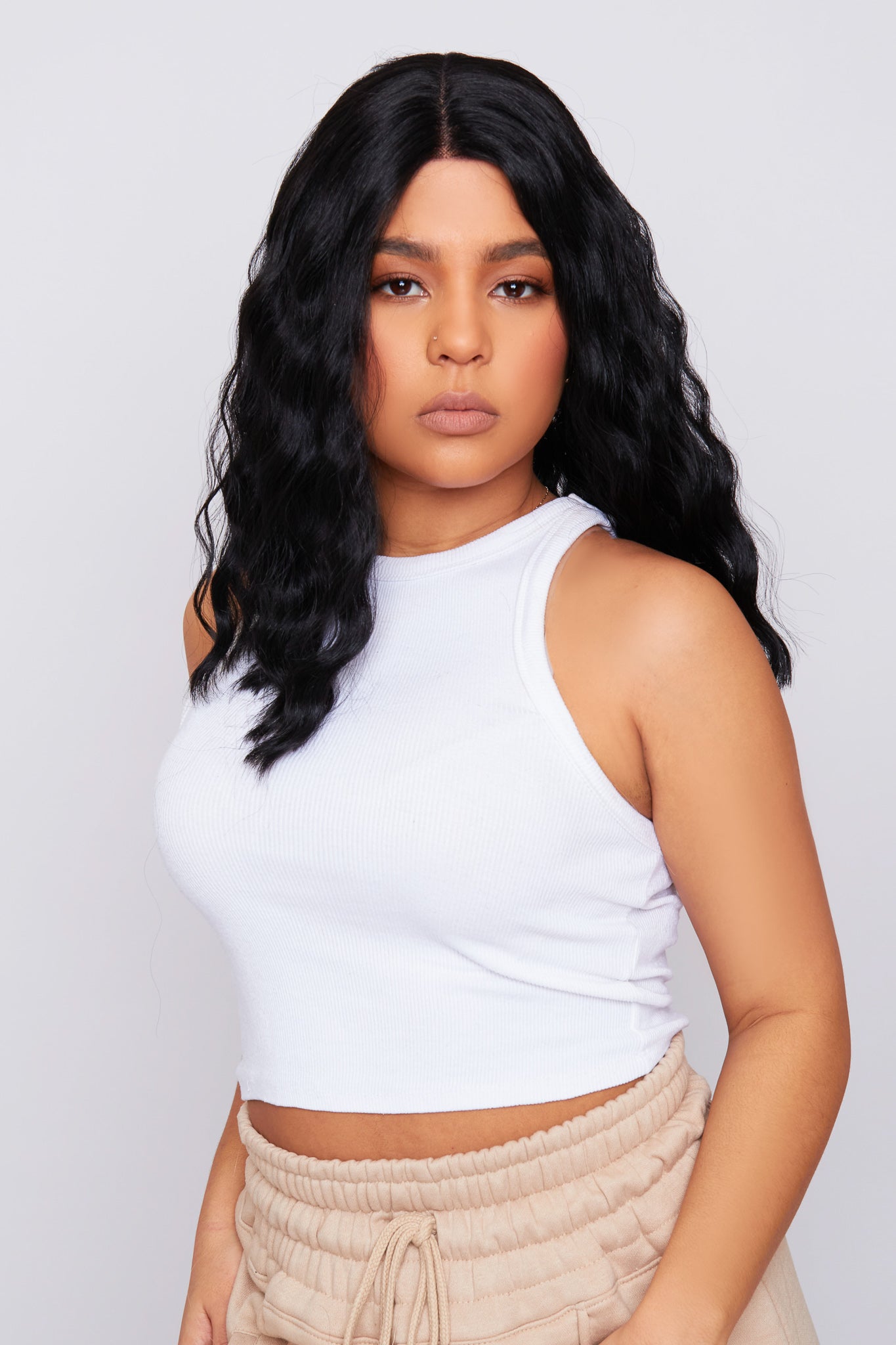 model 14-inch wavy black bob wig with soft waves and a sleek bob cut, made from premium synthetic hair