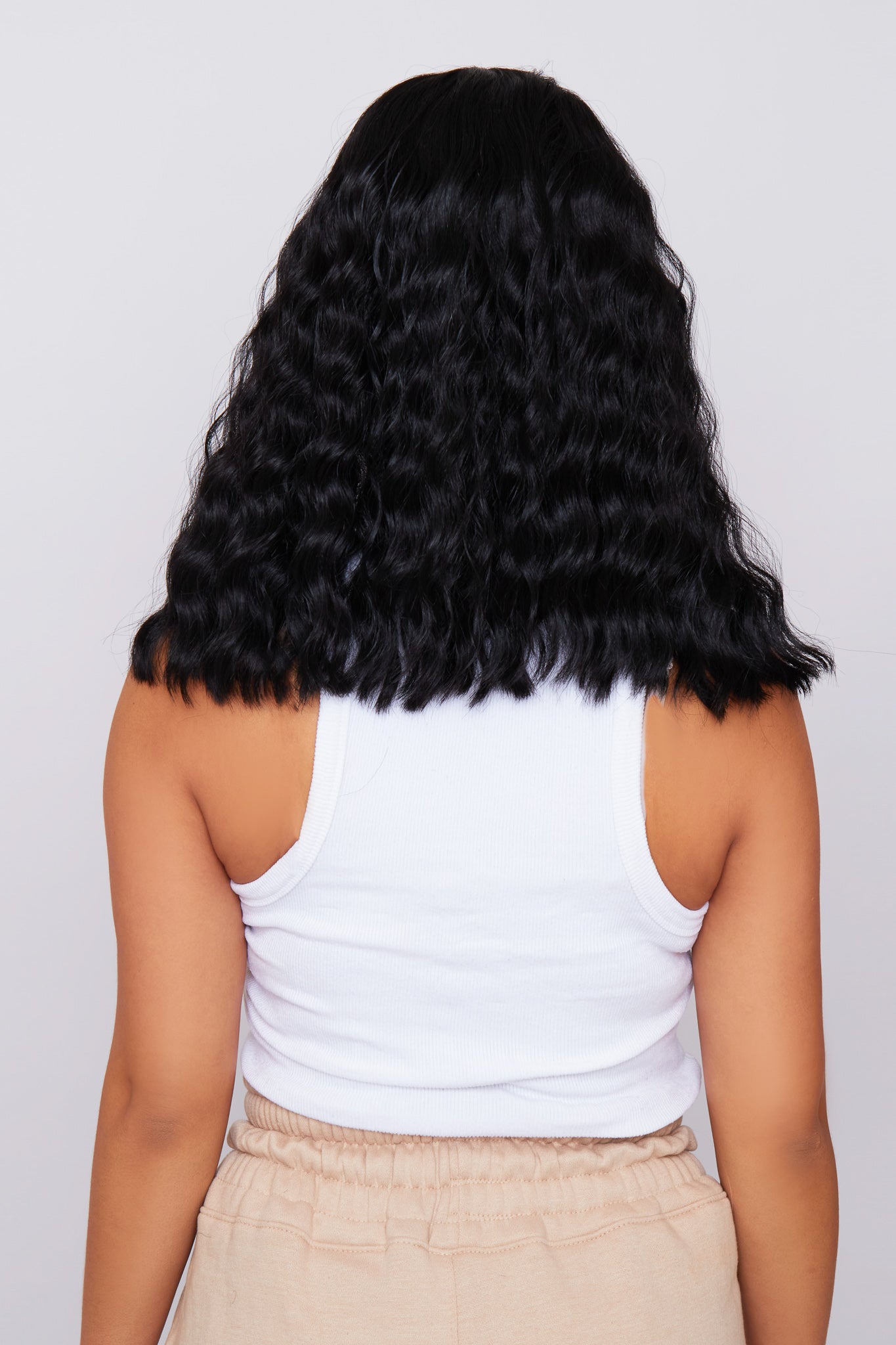 Back view of a wavy bob wig in black, emphasizing the elegant waves and premium synthetic fibers