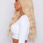 Blonde wavy wig with bangs showing cascading waves and vibrant color, synthetic hair option for stylish looks