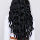 Back view of the 28-inch wavy black wig, showing the voluminous and smooth synthetic hair