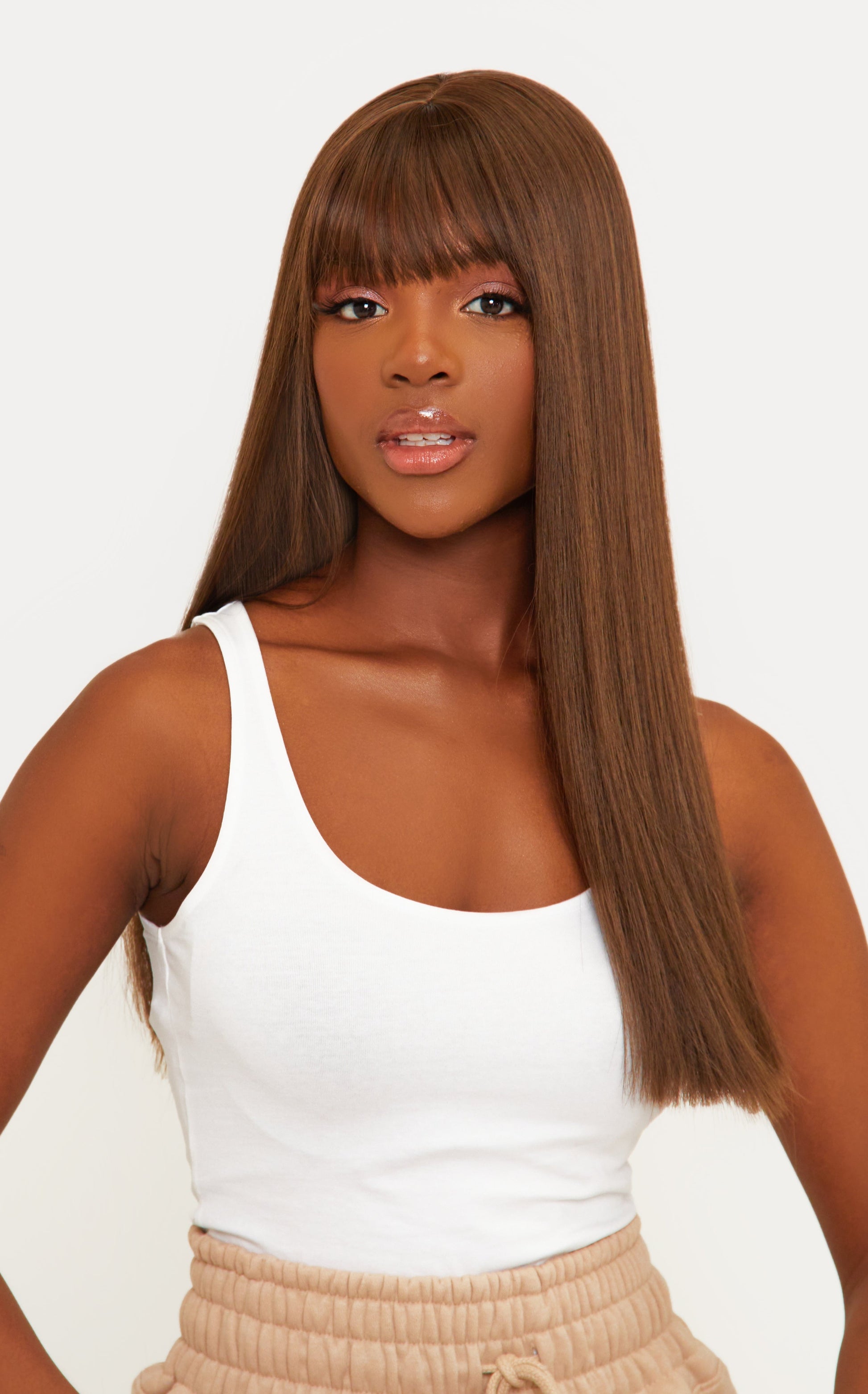 Close-up of a synthetic brown wig featuring chic bangs and a realistic texture