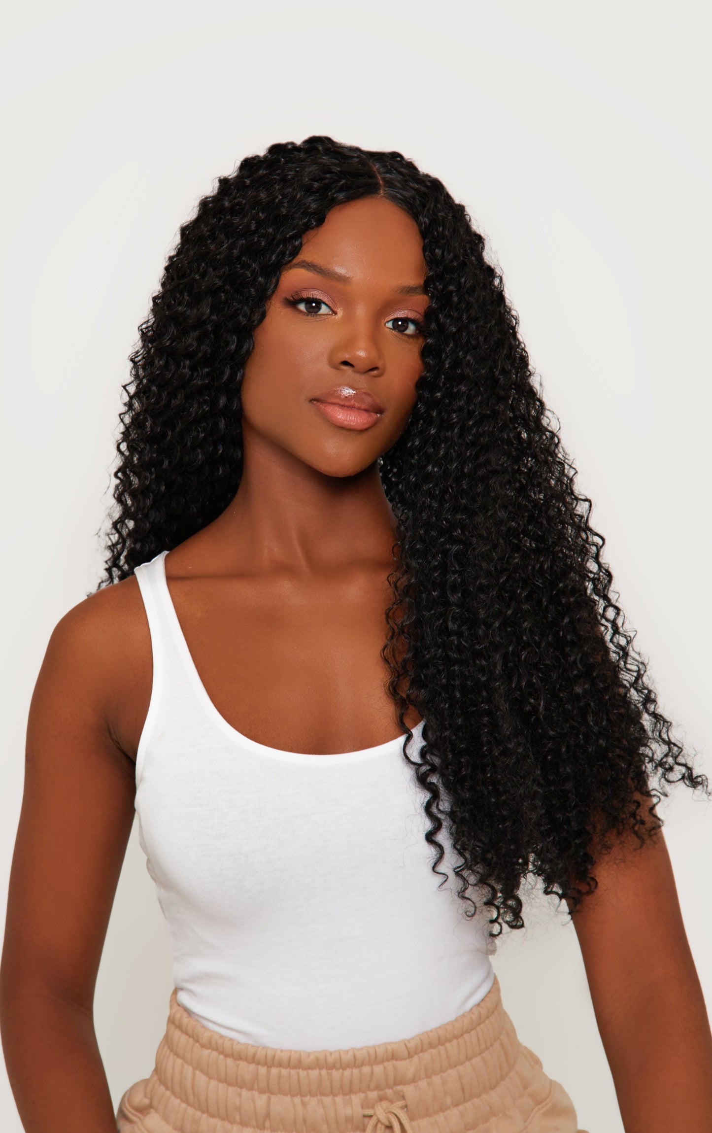 Kinky curly black wig with voluminous curls and a rich black color, made from high-quality synthetic hair